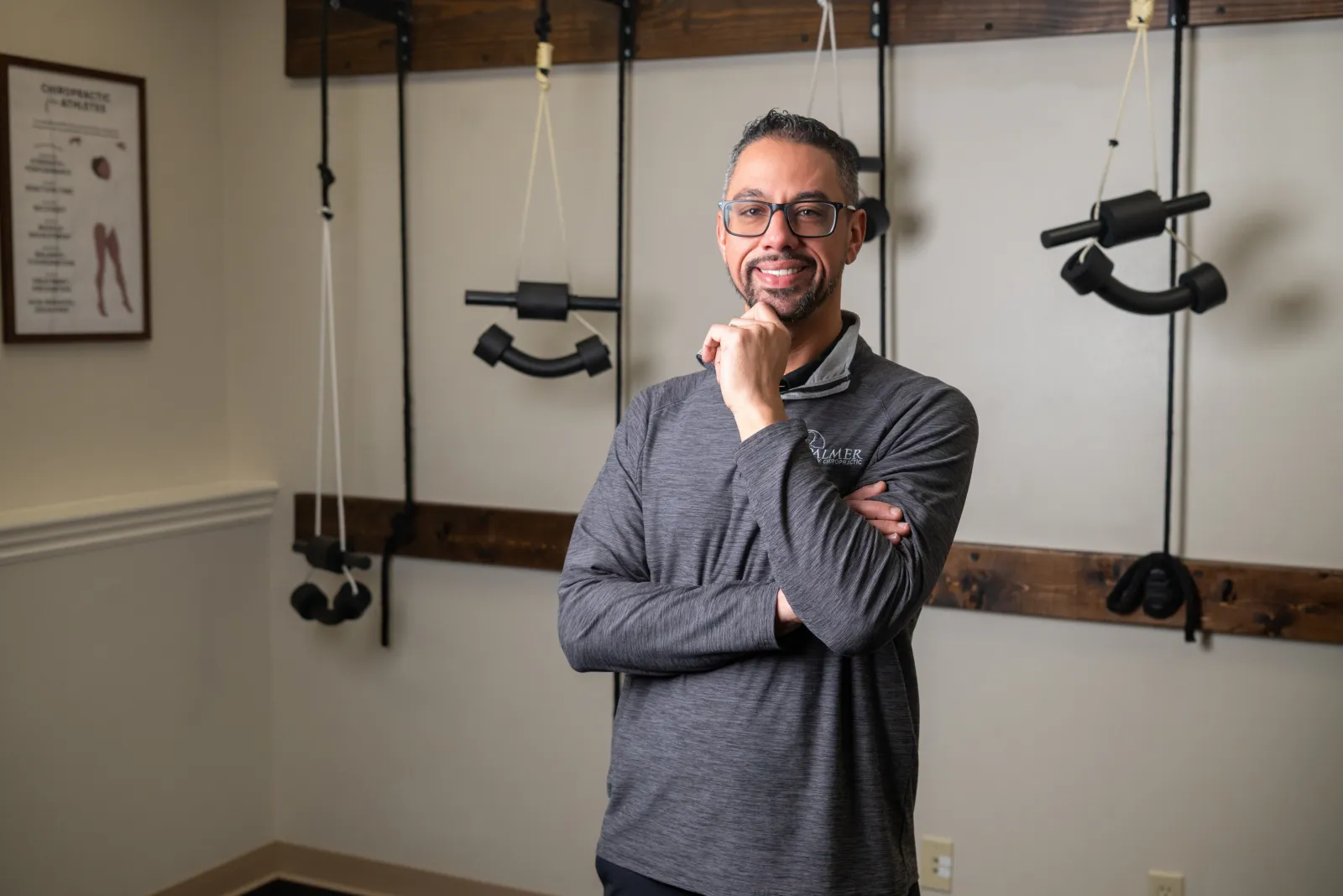 Dr. James Palmer standing beside rehabilitation equipment
