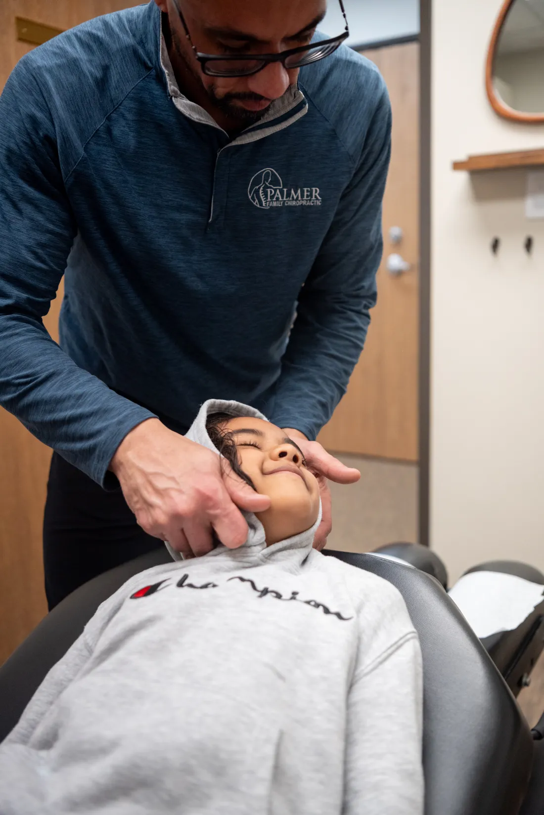 Dr. James Palmer positioning a young patient for cervical care