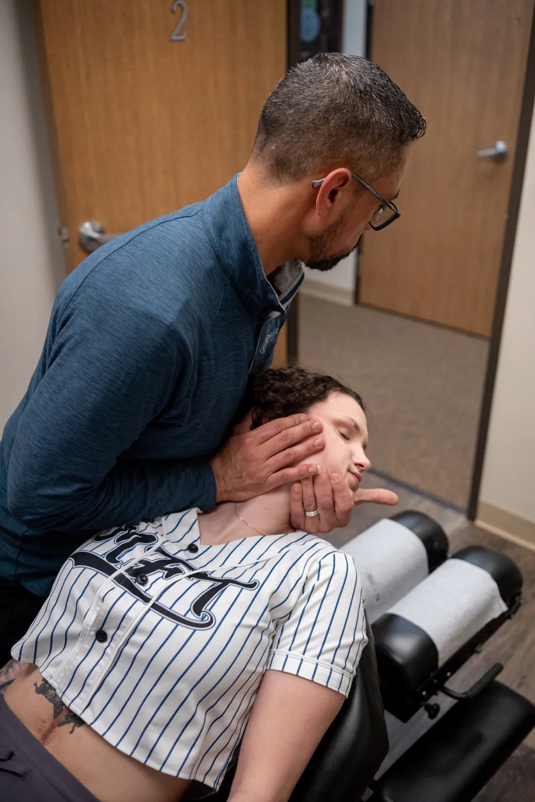 Close view of Dr. James Palmer positioning a patient for cervical care