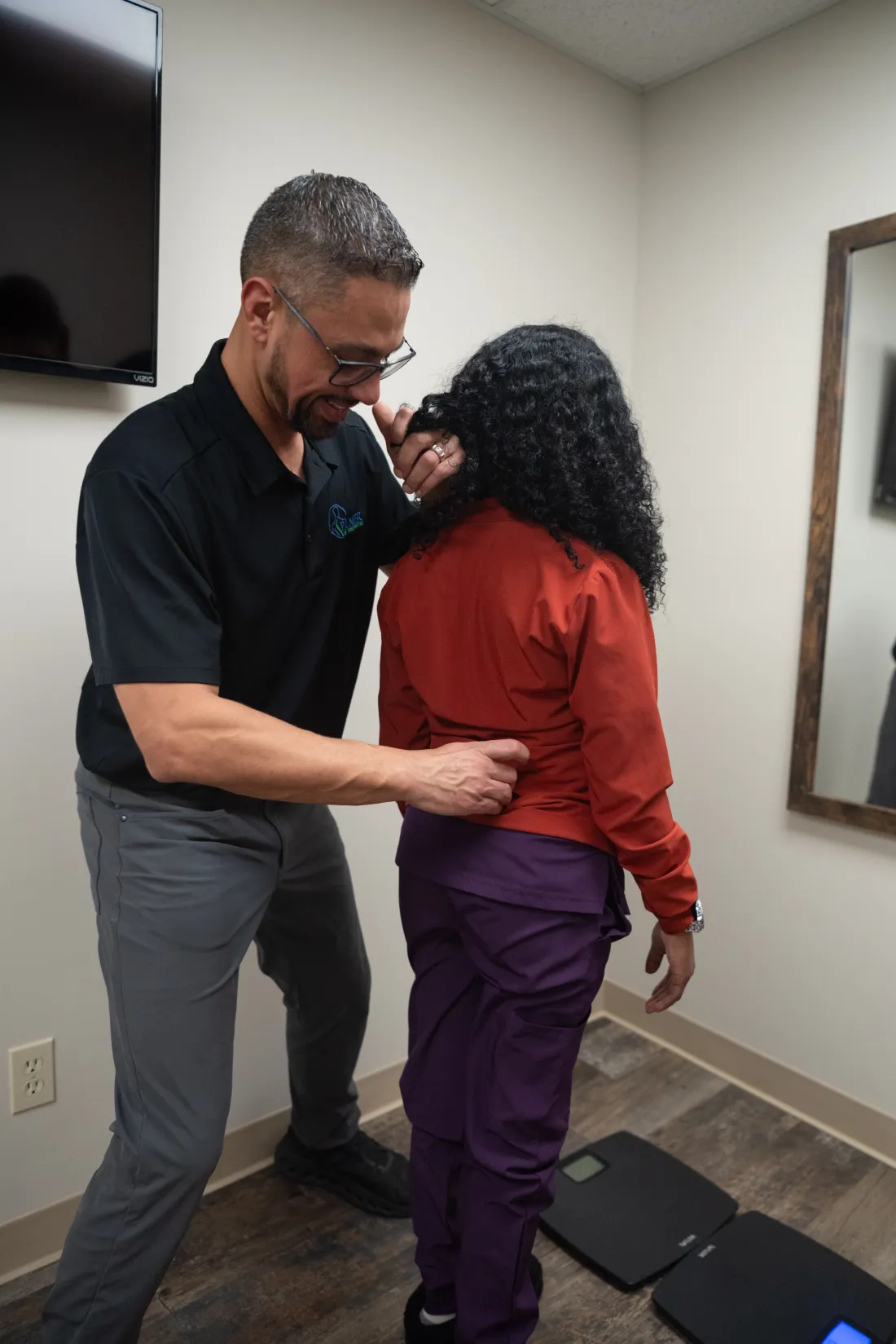 Dr. James Palmer observing a patient during a standing posture assessment
